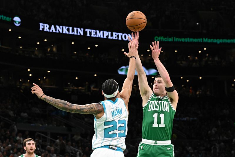 BOSTON, MASSACHUSETTS - APRIL 12: Payton Pritchard #11 of the Boston Celtics attempts a three-point basket against Tre Mann #23 of the Charlotte Hornets during the first quarter at the TD Garden on April 12, 2024 in Boston, Massachusetts. NOTE TO USER: User expressly acknowledges and agrees that, by downloading and or using this photograph, User is consenting to the terms and conditions of the Getty Images License Agreement. (Photo by Brian Fluharty/Getty Images)