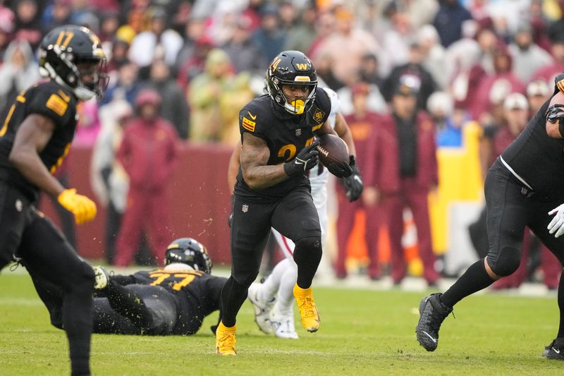 Washington Commanders running back Antonio Gibson (24) runs with the ball during the second half of an NFL football game against the Atlanta Falcons, Sunday, Nov. 27, 2022, in Landover, Md. (AP Photo/Alex Brandon)