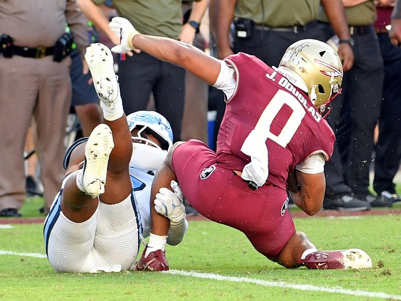 Nov 2, 2024; Tallahassee, Florida, USA;  Florida State Seminoes receiver Ja'Khi Douglas (0) is tackled in the backfield by North Carolina Tarheels linebacker Amare Campbell (17) in the third quarter at Doak S. Campbell Stadium. Mandatory Credit: Robert Myers-Imagn Images