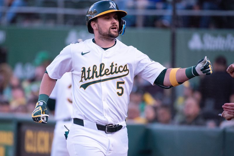 May 21, 2024; Oakland, California, USA; Oakland Athletics designated hitter J.D. Davis (5) celebrates with team mates after hitting a home run during the third inning against the Colorado Rockies at Oakland-Alameda County Coliseum. Mandatory Credit: Ed Szczepanski-USA TODAY Sports