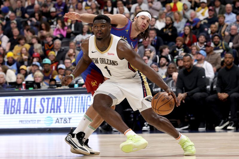 DENVER, COLORADO - JANUARY 12: Zion Williamson #1 of the New Orleans Pelicans drives past Aaron Gordon #50 the Denver Nuggets in the third quarter at Ball Arena on January 12, 2024 in Denver, Colorado. NOTE TO USER: User expressly acknowledges and agrees that, by downloading and or using this photograph, User is consenting to the terms and conditions of the Getty Images License Agreement.  (Photo by Matthew Stockman/Getty Images)