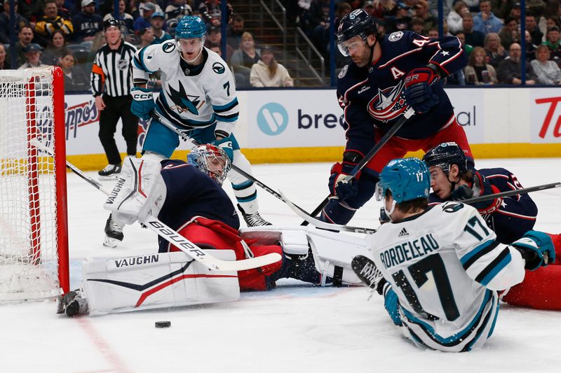 Mar 16, 2024; Columbus, Ohio, USA; Columbus Blue Jackets goalie Daniil Tarasov (40) makes a pad save on the shot from San Jose Sharks center Thomas Bordeleau (17) during the first period at Nationwide Arena. Mandatory Credit: Russell LaBounty-USA TODAY Sports