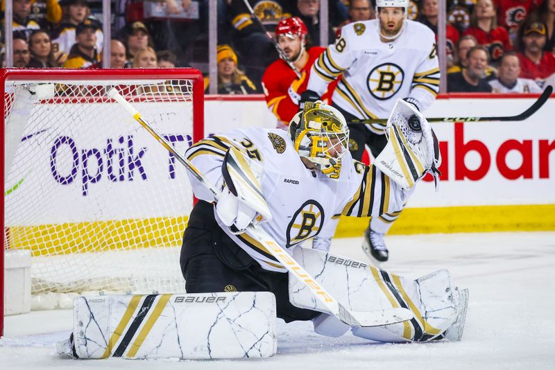 Feb 22, 2024; Calgary, Alberta, CAN; Boston Bruins goaltender Linus Ullmark (35) makes a save against the Calgary Flames during the second period at Scotiabank Saddledome. Mandatory Credit: Sergei Belski-USA TODAY Sports