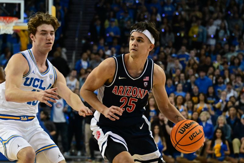 Mar 4, 2023; Los Angeles, California, USA;  Arizona Wildcats guard Kerr Kriisa (25) handles the ball as UCLA Bruins guard Russell Stong (43) defends during the first half at Pauley Pavilion presented by Wescom. Mandatory Credit: Richard Mackson-USA TODAY Sports