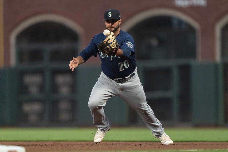 Jul 3, 2023; San Francisco, California, USA;  Seattle Mariners first baseman Mike Ford (20) juggles the ball during the seventh inning against the San Francisco Giants at Oracle Park. Mandatory Credit: Stan Szeto-USA TODAY Sports