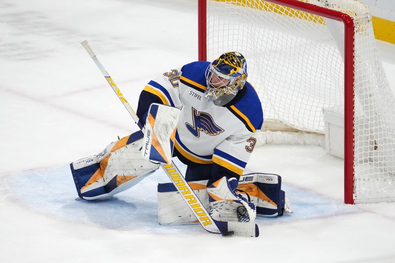 Dec 21, 2023; Sunrise, Florida, USA; St. Louis Blues goaltender Joel Hofer (30) stops the puck during the second period against the Florida Panthers at Amerant Bank Arena. Mandatory Credit: Jasen Vinlove-USA TODAY Sports