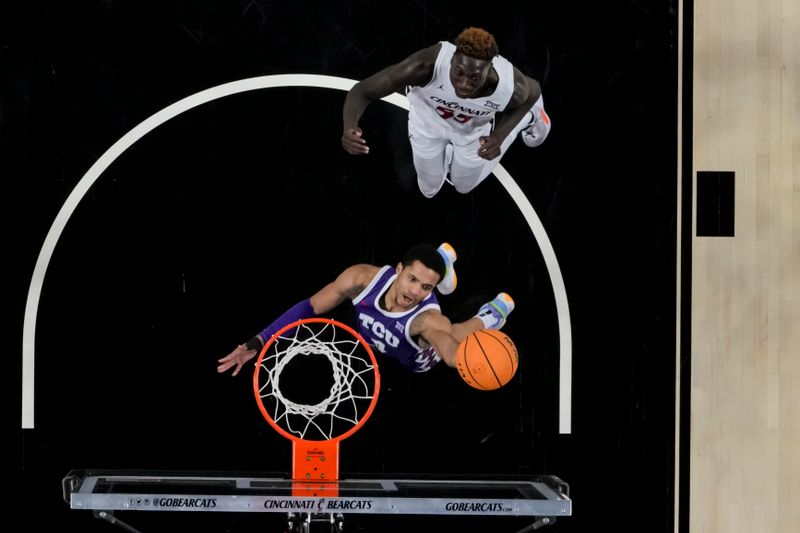 sJan 16, 2024; Cincinnati, Ohio, USA;  TCU Horned Frogs guard Jameer Nelson Jr. (4) drives to the basket against Cincinnati Bearcats forward Aziz Bandaogo (55) in the second half at Fifth Third Arena. Mandatory Credit: Aaron Doster-USA TODAY Sports