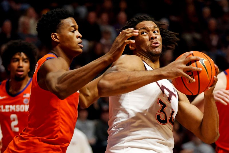 Jan 10, 2024; Blacksburg, Virginia, USA; Virginia Tech Hokies forward Mylyjael Poteat (34) drives to the basket against Clemson Tigers forward RJ Godfrey (10) during the second half at Cassell Coliseum. Mandatory Credit: Peter Casey-USA TODAY Sports