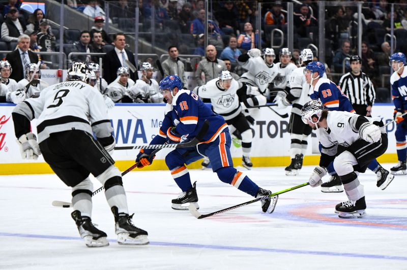 Dec 9, 2023; Elmont, New York, USA; New York Islanders right wing Cal Clutterbuck (15) skates with the puck against Los Angeles Kings defenseman Drew Doughty (8) and Los Angeles Kings right wing Adrian Kempe (9) during the second period at UBS Arena. Mandatory Credit: John Jones-USA TODAY Sports