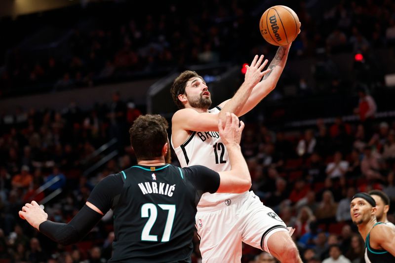 PORTLAND, OREGON - NOVEMBER 17: Joe Harris #12 of the Brooklyn Nets shoots during the third quarter against the Portland Trail Blazers at Moda Center on November 17, 2022 in Portland, Oregon. NOTE TO USER: User expressly acknowledges and agrees that, by downloading and or using this photograph, User is consenting to the terms and conditions of the Getty Images License Agreement. (Photo by Steph Chambers/Getty Images)