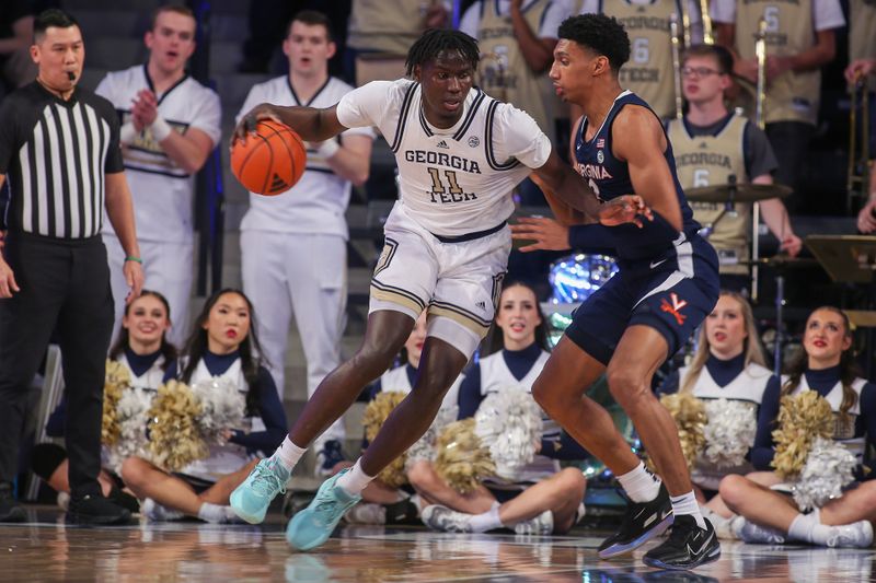 Jan 20, 2024; Atlanta, Georgia, USA; Georgia Tech Yellow Jackets forward Baye Ndongo (11) is defended by Virginia Cavaliers guard Ryan Dunn (13) in the first half at McCamish Pavilion. Mandatory Credit: Brett Davis-USA TODAY Sports
