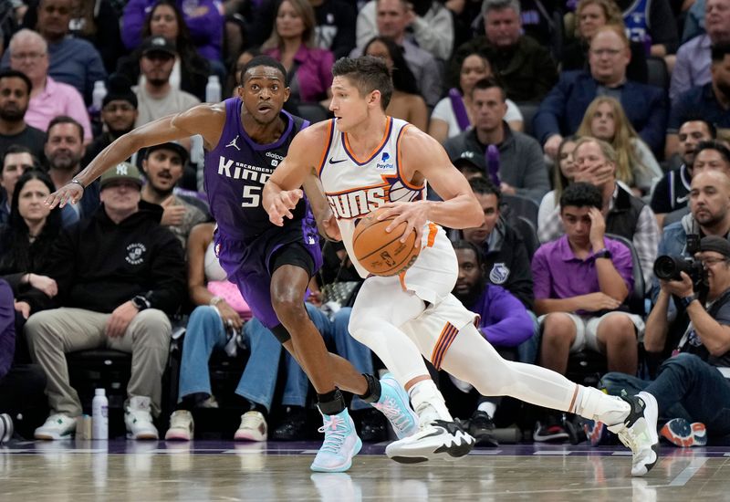 SACRAMENTO, CALIFORNIA - APRIL 12: Grayson Allen #8 of the Phoenix Suns dribbling the ball is guarded by De'Aaron Fox #5 of the Sacramento Kings during the second half of an NBA basketball game at Golden 1 Center on April 12, 2024 in Sacramento, California. NOTE TO USER: User expressly acknowledges and agrees that, by downloading and or using this photograph, User is consenting to the terms and conditions of the Getty Images License Agreement. (Photo by Thearon W. Henderson/Getty Images)