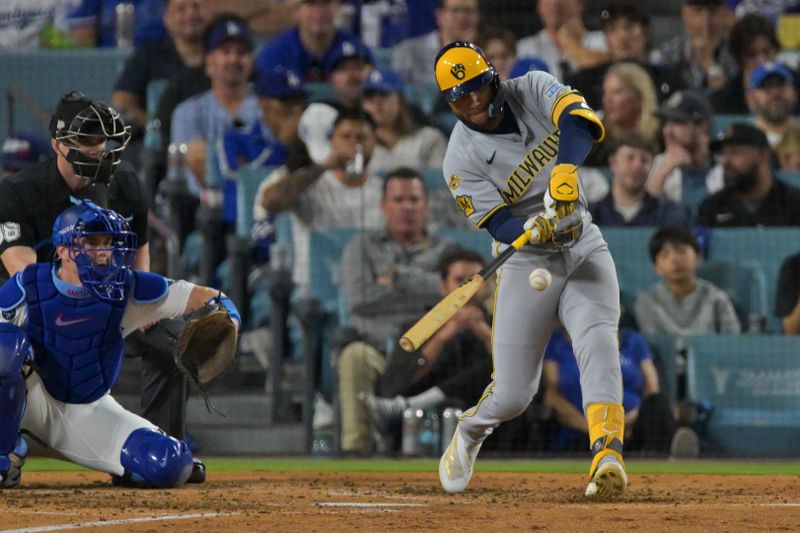 Oct 17, 2025; Los Angeles, California, USA; Milwaukee Brewers left fielder Jackson Chourio (11) doubles against the Los Angeles Dodgers during the fourth inning of game four of the NLCS round for the 2025 MLB playoffs at Dodger Stadium. Mandatory Credit: Jayne Kamin-Oncea-Imagn Images
