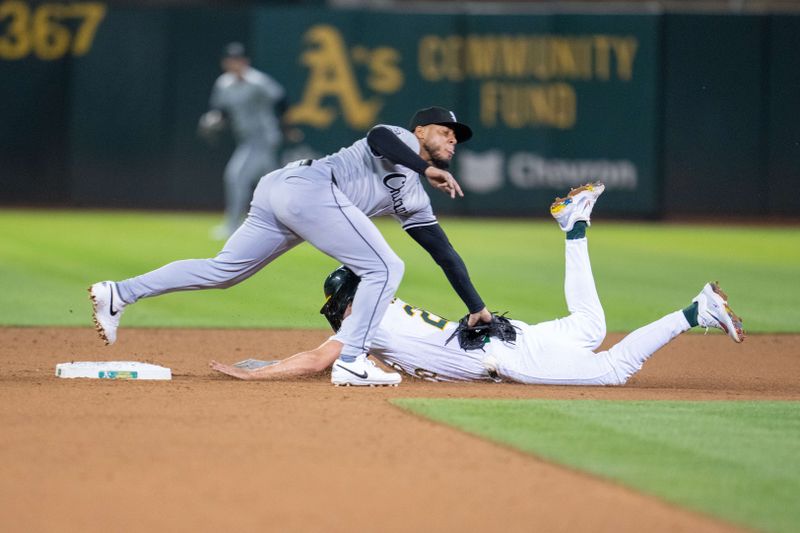 Aug 5, 2024; Oakland, California, USA;  Oakland Athletics second baseman Zack Gelof (20) steals second base against Chicago White Sox second baseman Lenyn Sosa (50) during the eighth inning at Oakland-Alameda County Coliseum. Mandatory Credit: Neville E. Guard-USA TODAY Sports