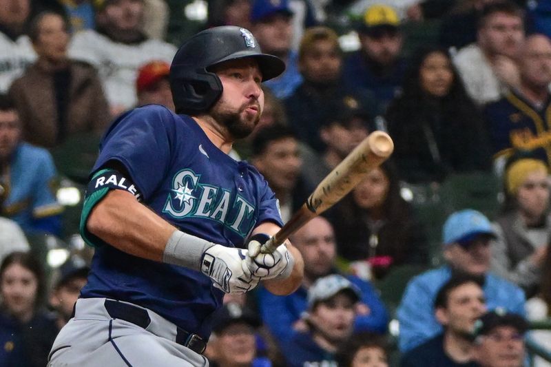 Apr 5, 2024; Milwaukee, Wisconsin, USA; Seattle Mariners catcher Cal Raleigh (29) hits a single to drive in a run in the sixth inning against the Milwaukee Brewers at American Family Field. Mandatory Credit: Benny Sieu-USA TODAY Sports