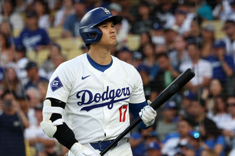 Jul 5, 2024; Los Angeles, California, USA;  Los Angeles Dodgers designated hitter Shohei Ohtani (17) looks on at the on deck circle during the game against the Milwaukee Brewers at Dodger Stadium. Mandatory Credit: Kiyoshi Mio-USA TODAY Sports