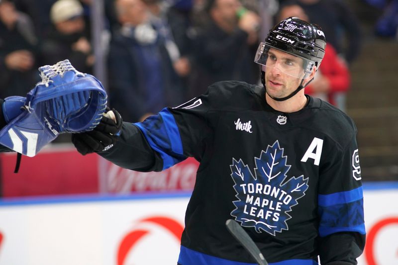 Dec 2, 2024; Toronto, Ontario, CAN; Toronto Maple Leafs forward John Tavares (91) celebrates after his goal against the Chicago Blackhawks during the second period at Scotiabank Arena. Mandatory Credit: John E. Sokolowski-Imagn Images