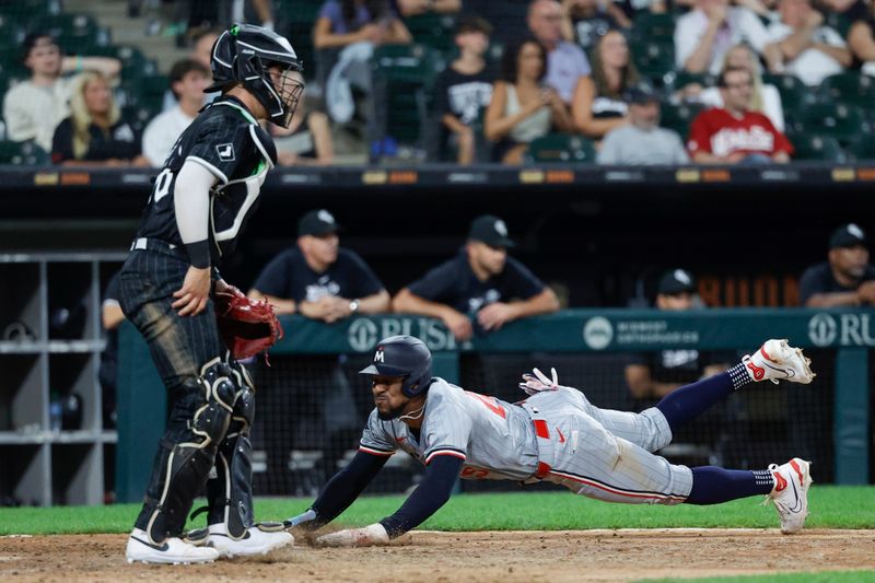 Jul 8, 2024; Chicago, Illinois, USA; Minnesota Twins outfielder Byron Buxton (25) slides to score against the Chicago White Sox during the 11th inning at Guaranteed Rate Field. Mandatory Credit: Kamil Krzaczynski-USA TODAY Sports