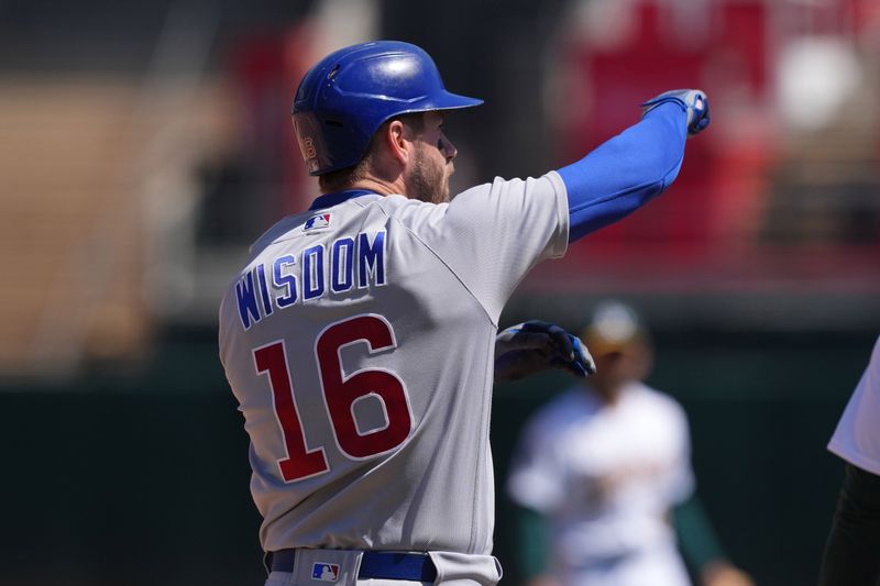 Apr 19, 2023; Oakland, California, USA; Chicago Cubs right fielder Patrick Wisdom (16) gestures after hitting an RBI-triple against the Oakland Athletics during the sixth inning at Oakland-Alameda County Coliseum. Mandatory Credit: Darren Yamashita-USA TODAY Sports