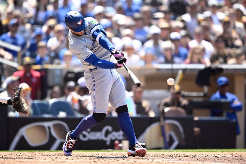 Apr 21, 2024; San Diego, California, USA; Toronto Blue Jays right fielder George Springer (4) hits a single against the San Diego Padres during the sixth inning at Petco Park. Mandatory Credit: Orlando Ramirez-USA TODAY Sports