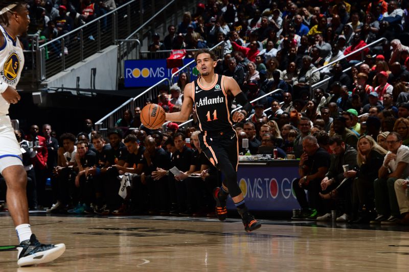 ATLANTA, GA - MARCH 17: Trae Young #11 of the Atlanta Hawks dribbles the ball during the game against the Golden State Warriors on March 17, 2023 at State Farm Arena in Atlanta, Georgia.  NOTE TO USER: User expressly acknowledges and agrees that, by downloading and/or using this Photograph, user is consenting to the terms and conditions of the Getty Images License Agreement. Mandatory Copyright Notice: Copyright 2023 NBAE (Photo by Scott Cunningham/NBAE via Getty Images)