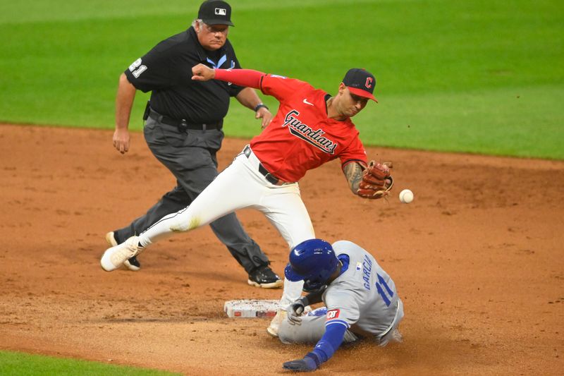 Aug 27, 2024; Cleveland, Ohio, USA; Kansas City Royals second baseman Maikel Garcia (11) steals second base beside Cleveland Guardians shortstop Brayan Rocchio (4) in the fifth inning at Progressive Field. Mandatory Credit: David Richard-USA TODAY Sports