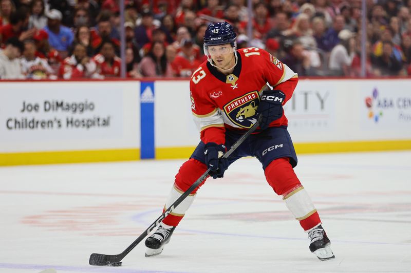 Apr 23, 2024; Sunrise, Florida, USA; Florida Panthers center Sam Reinhart (13) moves the puck against the Tampa Bay Lightning during the second period in game two of the first round of the 2024 Stanley Cup Playoffs at Amerant Bank Arena. Mandatory Credit: Sam Navarro-USA TODAY Sports