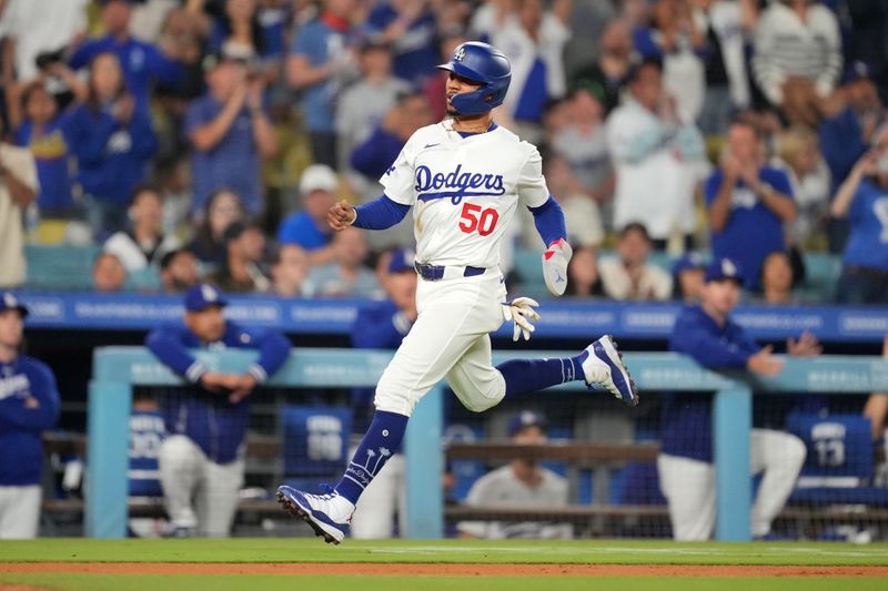 Jun 14, 2024; Los Angeles, California, USA; Los Angeles Dodgers shortstop Mookie Betts (50) rounds third base to score in the eighth inning as Kansas City Royals catcher Salvador Perez (13) watches at Dodger Stadium. Mandatory Credit: Kirby Lee-USA TODAY Sports