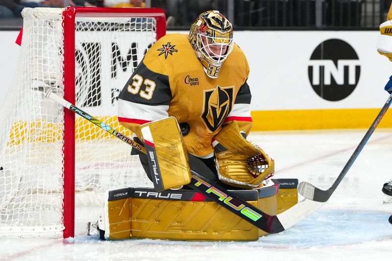 Apr 14, 2024; Las Vegas, Nevada, USA; Vegas Golden Knights goaltender Adin Hill (33) makes a save against the Colorado Avalanche during the second period at T-Mobile Arena. Mandatory Credit: Stephen R. Sylvanie-USA TODAY Sports