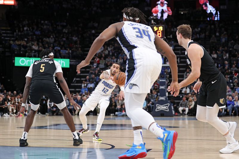 MEMPHIS, TENNESSEE - JANUARY 26: Trevelin Queen #12 of the Orlando Magic looks to pass during the first half against the Memphis Grizzlies at FedExForum on January 26, 2024 in Memphis, Tennessee. NOTE TO USER: User expressly acknowledges and agrees that, by downloading and or using this photograph, User is consenting to the terms and conditions of the Getty Images License Agreement. (Photo by Justin Ford/Getty Images)