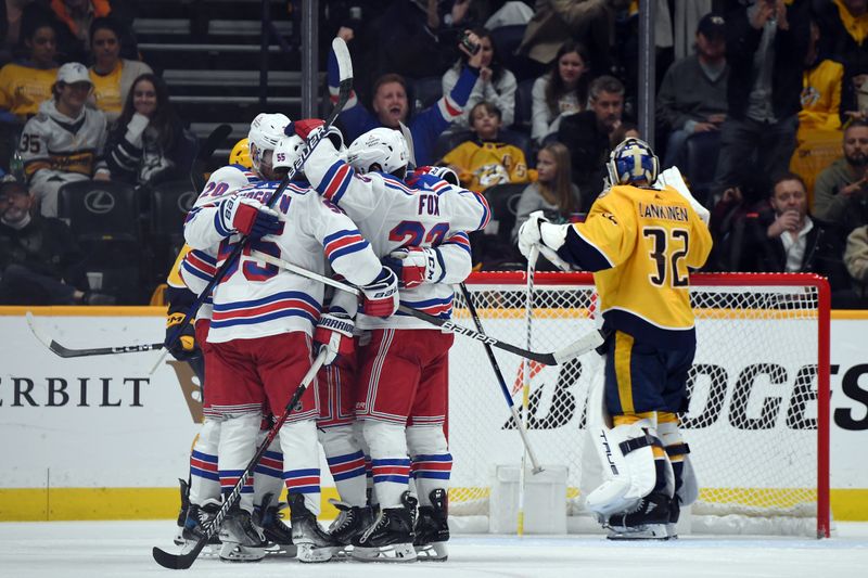 Dec 2, 2023; Nashville, Tennessee, USA; New York Rangers defenseman Ryan Lindgren (55) is congratulated by teammates after a goal against Nashville Predators goaltender Kevin Lankinen (32) during the third period at Bridgestone Arena. Mandatory Credit: Christopher Hanewinckel-USA TODAY Sports