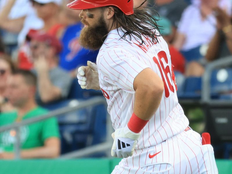 Mar 5, 2026; Clearwater, Florida, USA; Philadelphia Phillies infielder Brandon Marsh (16) singles during the fifth inning against the Boston Red Sox at BayCare Ballpark. Mandatory Credit: Kim Klement Neitzel-Imagn Images