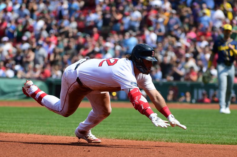 May 26, 2024; Boston, Massachusetts, USA;  Boston Red Sox right fielder Wilyer Abreu (52) slides into third base for a triple during the fourth inning against the Milwaukee Brewers at Fenway Park. Mandatory Credit: Bob DeChiara-USA TODAY Sports