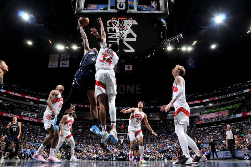 ORLANDO, FL - MARCH 17: Paolo Banchero #5 of the Orlando Magic drives to the basket during the game against the Toronto Raptors on March 17, 2024 at the Kia Center in Orlando, Florida. NOTE TO USER: User expressly acknowledges and agrees that, by downloading and or using this photograph, User is consenting to the terms and conditions of the Getty Images License Agreement. Mandatory Copyright Notice: Copyright 2024 NBAE (Photo by Fernando Medina/NBAE via Getty Images)