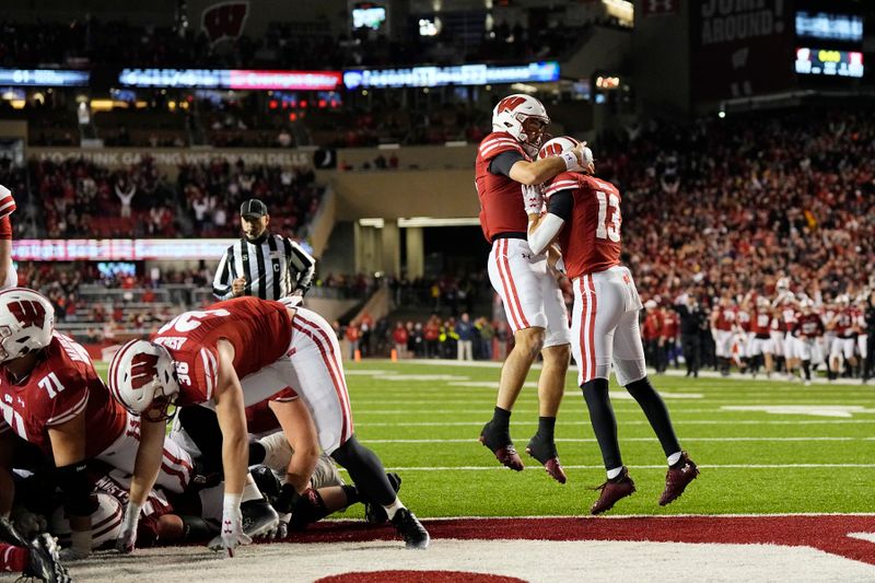 Nov 18, 2023; Madison, Wisconsin, USA;  Wisconsin Badgers quarterback Tanner Mordecai (8) celebrates with wide receiver Chimere Dike (13) after scoring a touchdown during overtime against the Nebraska Cornhuskers at Camp Randall Stadium. Mandatory Credit: Jeff Hanisch-USA TODAY Sports