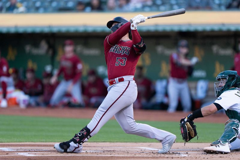 May 16, 2023; Oakland, California, USA;  Arizona Diamondbacks first baseman Christian Walker (53) hits a two run home run during the first inning against the Oakland Athletics at Oakland-Alameda County Coliseum. Mandatory Credit: Stan Szeto-USA TODAY Sports