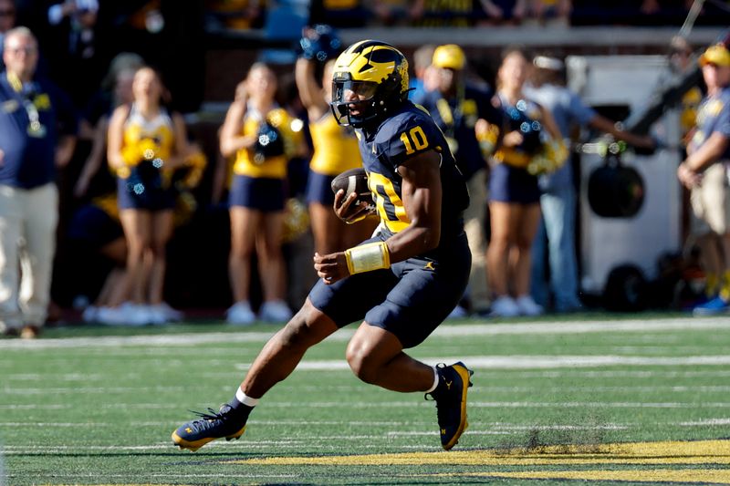 Sep 21, 2024; Ann Arbor, Michigan, USA;  Michigan Wolverines quarterback Alex Orji (10) rushes in the first half against the USC Trojans at Michigan Stadium. Mandatory Credit: Rick Osentoski-Imagn Images