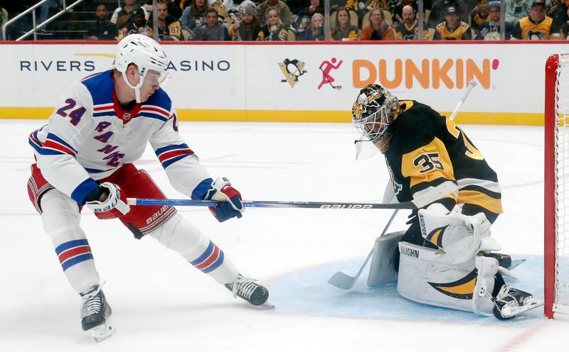 Oct 9, 2024; Pittsburgh, Pennsylvania, USA;  Pittsburgh Penguins goaltender Tristan Jarry (35) makes a save against New York Rangers right wing Kaapo Kakko (24) during the second period at PPG Paints Arena. Mandatory Credit: Charles LeClaire-Imagn Images