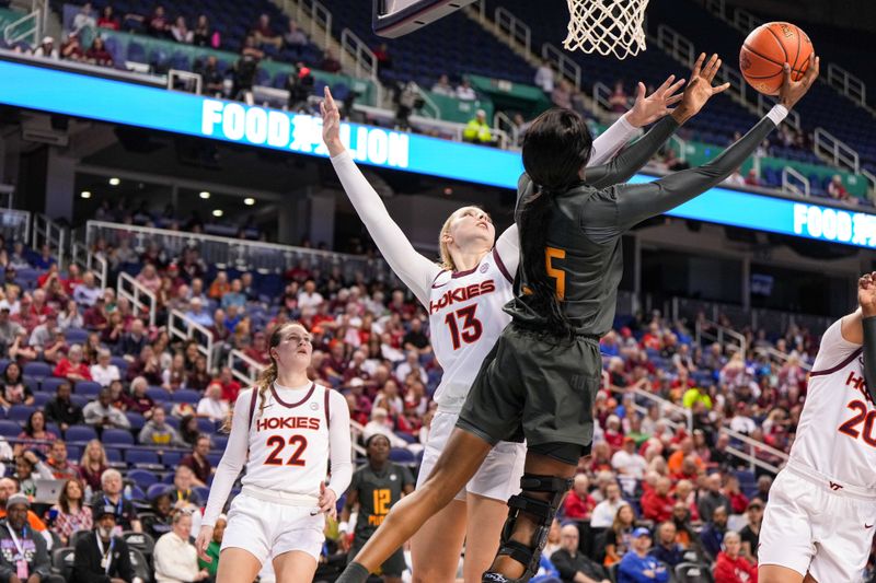 Mar 8, 2024; Greensboro, NC, USA; Miami Hurricanes guard Jaida Patrick (5) shoots the ball over Virginia Tech Hokies center Clara Strack (13) in the second half at Greensboro Coliseum. Mandatory Credit: David Yeazell-USA TODAY Sports