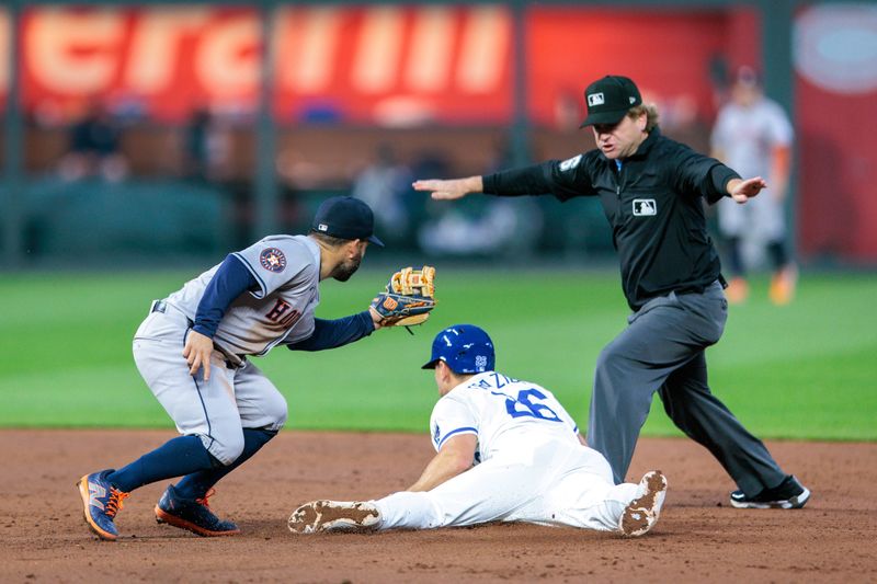 Apr 10, 2024; Kansas City, Missouri, USA; Kansas City Royals bench coach Paul Hoover (26) steals 2nd base around Houston Astros second base Jose Altuve (27) during the third inning at Kauffman Stadium. Mandatory Credit: William Purnell-USA TODAY Sports