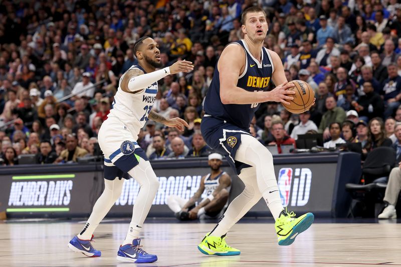 DENVER, COLORADO - APRIL 10: Nikola Jokic #15 of the Denver Nuggets drives against Monte Morris #23 of the Minnesota Timberwolves during the first quarter at Ball Arena on April 10, 2024 in Denver, Colorado. NOTE TO USER: User expressly acknowledges and agrees that, by downloading and or using this photograph, User is consenting to the terms and conditions of the Getty Images License Agreement.  (Photo by Matthew Stockman/Getty Images)