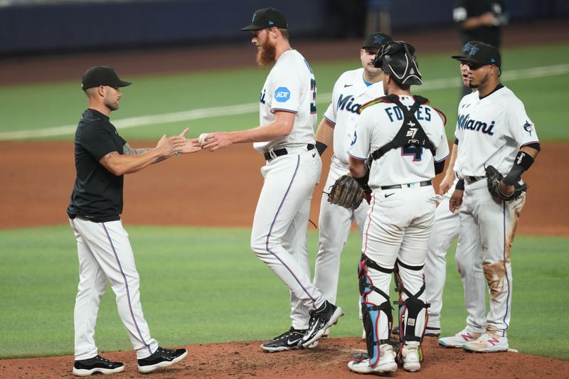 Aug 30, 2023; Miami, Florida, USA; Miami Marlins manager Skip Schumaker (55) takes the ball from Miami Marlins relief pitcher A.J. Puk (35) in the seventh inning against the Tampa Bay Rays at loanDepot Park. Mandatory Credit: Jim Rassol-USA TODAY Sports