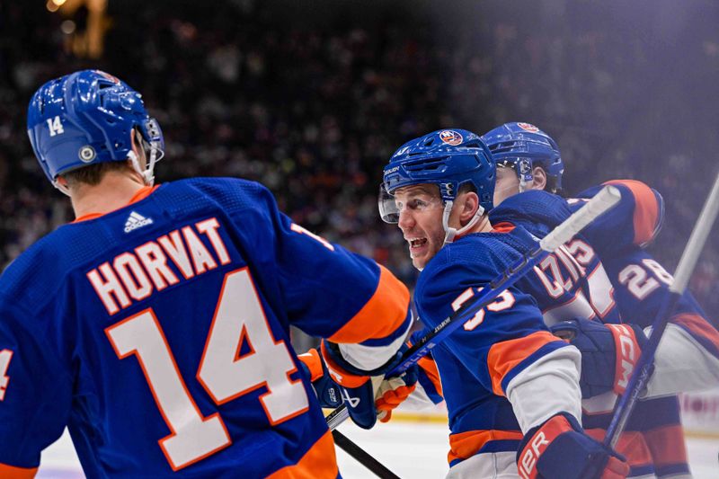 Apr 17, 2024; Elmont, New York, USA;  New York Islanders center Casey Cizikas (53) celebrates his goal against the Pittsburgh Penguins with center Bo Horvat (14) and defenseman Alexander Romanov (28) during the second period at UBS Arena. Mandatory Credit: Dennis Schneidler-USA TODAY Sports