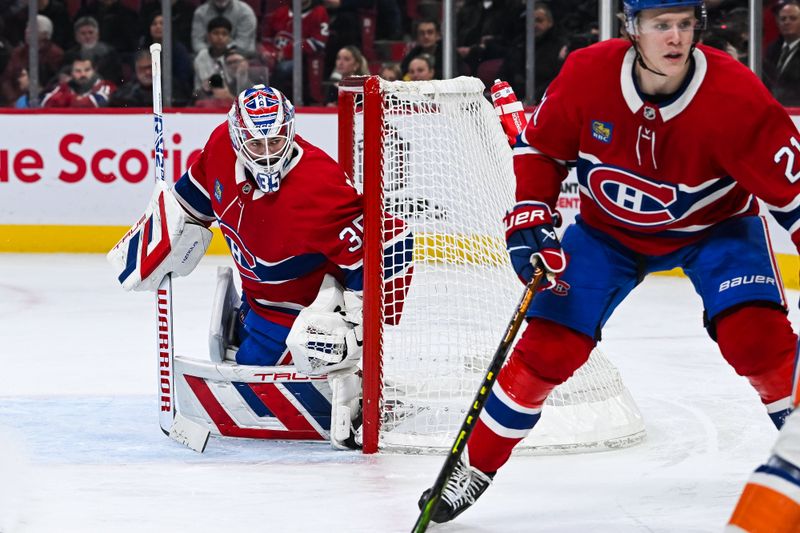 Dec 3, 2024; Montreal, Quebec, CAN; Montreal Canadiens goalie Sam Montembeault (35) tracks the play behind his net against the New York Islanders during the second period at Bell Centre. Mandatory Credit: David Kirouac-Imagn Images