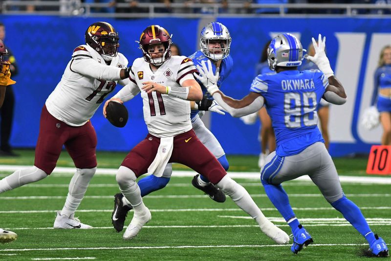 Washington Commanders quarterback Carson Wentz (11) is pressured by Detroit Lions linebacker Julian Okwara (99) during the first half of an NFL football game Sunday, Sept. 18, 2022, in Detroit. (AP Photo/Lon Horwedel)