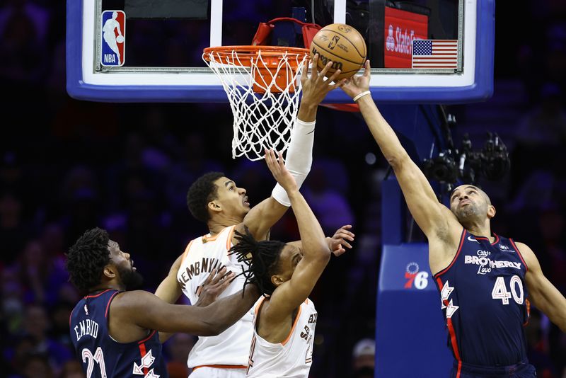 PHILADELPHIA, PENNSYLVANIA - JANUARY 22: Victor Wembanyama #1 of the San Antonio Spurs and Nicolas Batum #40 of the Philadelphia 76ers reach for a rebound during the first quarter at the Wells Fargo Center on January 22, 2024 in Philadelphia, Pennsylvania. NOTE TO USER: User expressly acknowledges and agrees that, by downloading and or using this photograph, User is consenting to the terms and conditions of the Getty Images License Agreement. (Photo by Tim Nwachukwu/Getty Images)