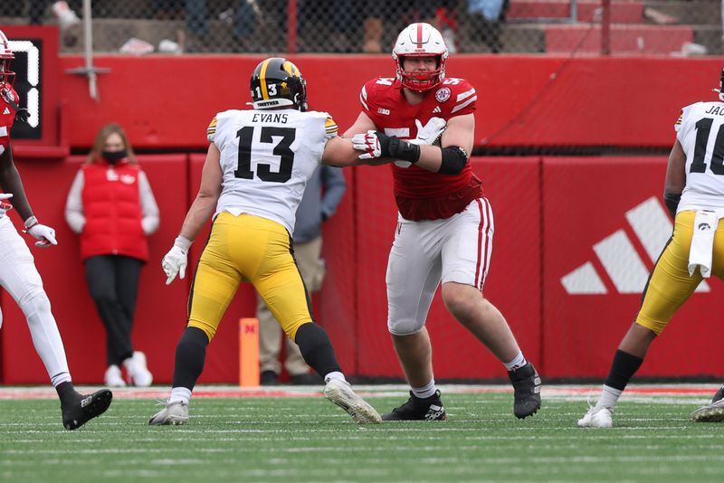 Nov 24, 2023; Lincoln, Nebraska, USA; Nebraska Cornhuskers offensive lineman Bryce Benhart (54) blocks Iowa Hawkeyes defensive end Joe Evans (13) at Memorial Stadium. Mandatory Credit: Reese Strickland-USA TODAY Sports