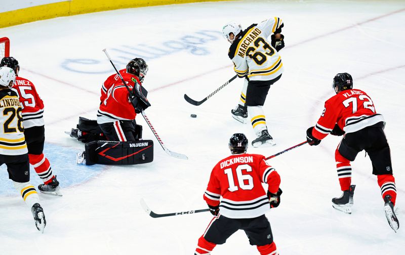 Dec 4, 2024; Chicago, Illinois, USA; Boston Bruins left wing Brad Marchand (63) scores against the Chicago Blackhawks during the second period at United Center. Mandatory Credit: Kamil Krzaczynski-Imagn Images