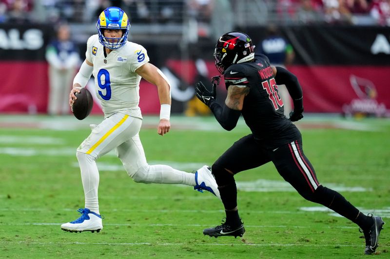 Los Angeles Rams quarterback Matthew Stafford (9) scrambles under pressure from Arizona Cardinals linebacker Josh Woods during the second half of an NFL football game, Sunday, Nov. 26, 2023, in Glendale, Ariz. (AP Photo/Ross D. Franklin)