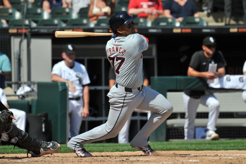 Aug 25, 2024; Chicago, Illinois, USA; Detroit Tigers second base Andy Ibanez (77) hits a sacrifice ground ball RBI during the fifth inning against the Chicago White Sox at Guaranteed Rate Field. Mandatory Credit: Patrick Gorski-USA TODAY Sports